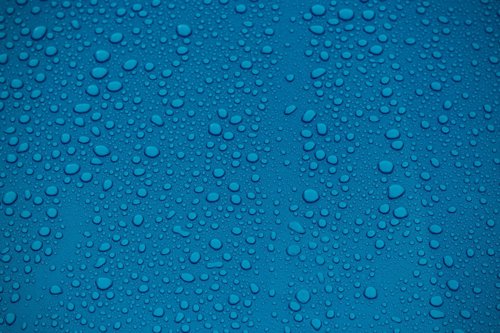 clear water drops on blue background