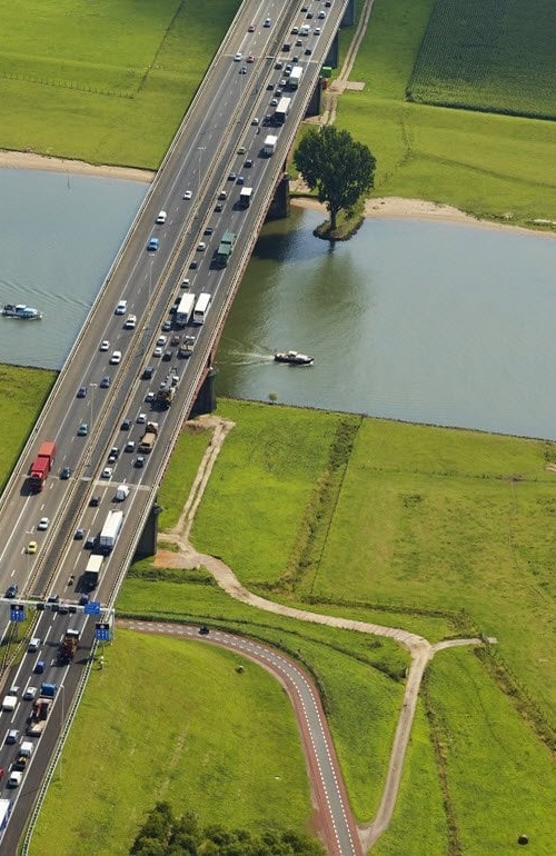 Road with traffic in a landscape with water