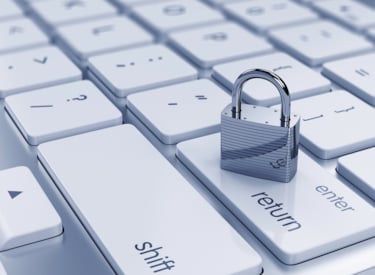 Small lock standing on top of keyboard